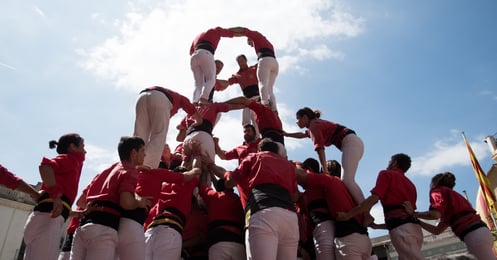 a group of people forming a human tower castle